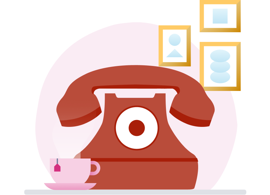 Red home telephone with a cup of tea and photo frames in the background